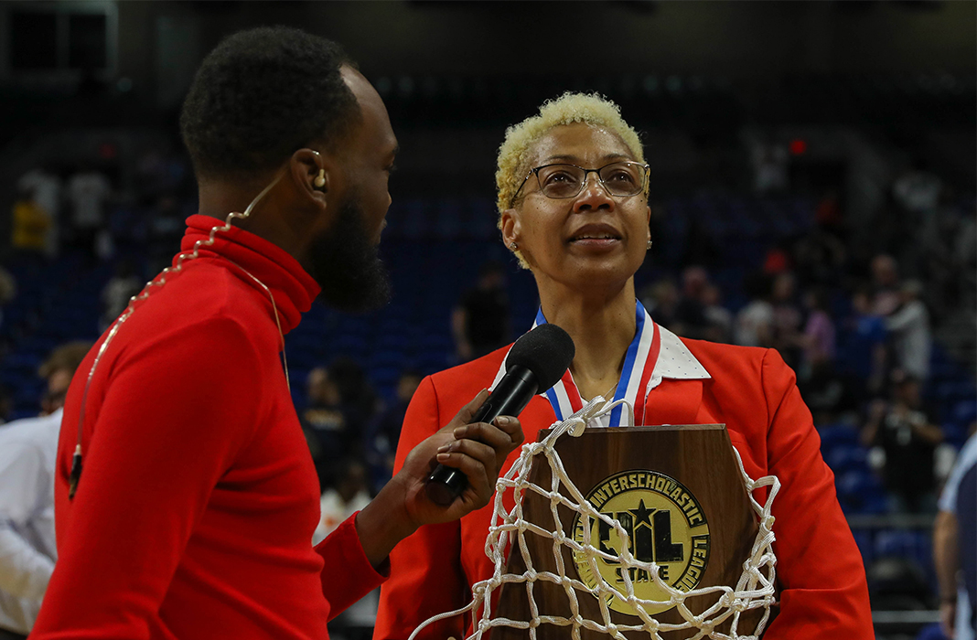 Coach Monesha Allen Holding a Trophy